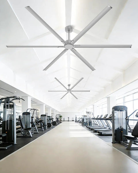 No Sweat 120 Inch HVLS Ceiling Fan For Shops And Gyms in a bright gym, featuring aluminum blades and smooth design.