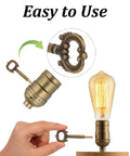 Two antique-brass lamp turn knobs with ornate keys for table or floor lamps; metal socket replacement knobs