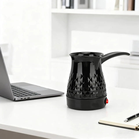 Go To Electric Coffee Maker 600ml Portable Stainless Steel Pot With Anti Scald Dual Protection on a desk next to a laptop