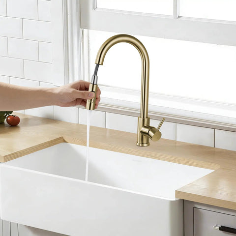 Sink Faucet,360°Pull-Out Spray,Brushed Steel Hot and Cold Rotation (Gold) in use over a white sink with water flowing.