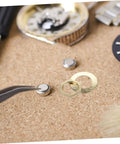 Close-up of Clock Movement Nut Set With Washers 14 Pcs Replacement Parts Kit for DIY clock repair on a cork surface.