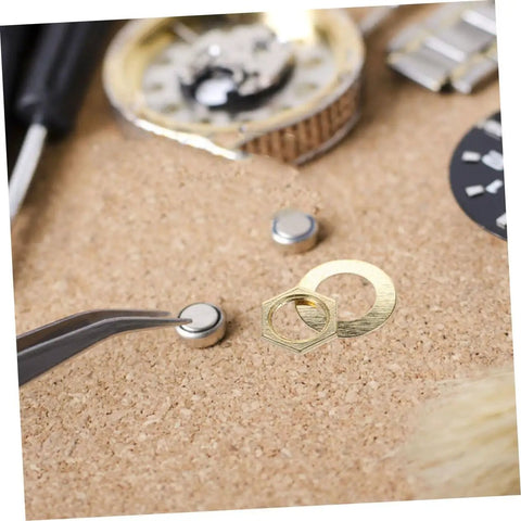 Close-up of Clock Movement Nut Set With Washers 14 Pcs Replacement Parts Kit for DIY clock repair on a cork surface.