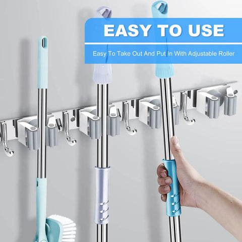 Broom And Mop Holder Wall Mount Organizer with Five Racks and Four Hooks in use, holding cleaning tools neatly and accessibly.