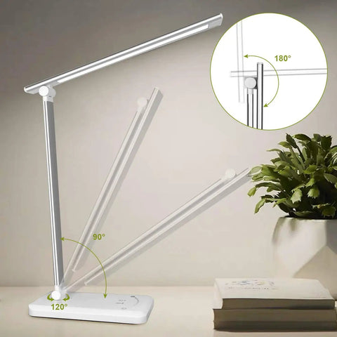 LED Touch Desk Lamp With USB Charging Port And 5 Lighting Modes and 5 Brightness Levels Auto Shutoff and Sleep Timer for Bedroom and Office Sleek and Smart Eye Friendly Flicker Free Light Silver Finish showing adjustable arm angles on desk next to plant and books.