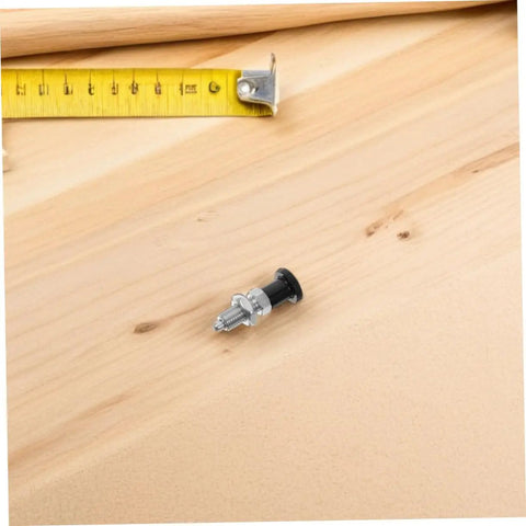 Built Tough Stainless Steel Reset Spring Plunger Featuring Self Locking Control Knob And Rapid Return Indexing Pin on wooden surface.