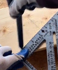 Hands using 7 Inch Speed Square Blue For Framing And Woodworking With Multi Gradation Markings to mark angles on a wooden board