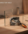 Heavy Duty 90 Degree Corner Clamp For Wood And Metal Fab securing glass at a perfect right angle on a workbench.