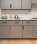 Six Pack 6 Inch Cabinet Pulls Sleek Matte Black Stainless Steel Kitchen Cupboard Handles Center To Center 3.75 Inch Spacing Durable Modern Hardware For Cabinets installed on grey cabinetry in a kitchen setting.