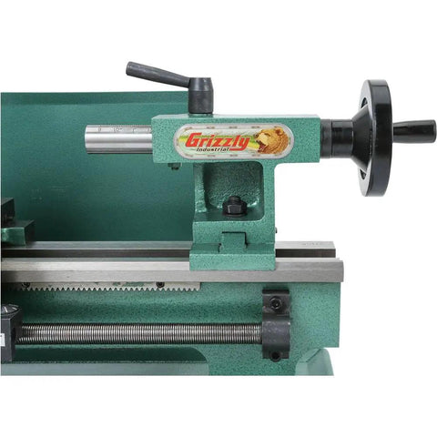 Close-up view of the Grizzly Industrial 7X12 Inch Mini Metal Lathe, showcasing precision machining components and variable speed drive features.