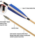 Close-up of 31 Inch Wooden Archery Arrows For Longbow And Recurve, featuring blue 5" turkey feathers, and Indonesian White Wood shaft.