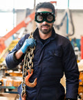 Top Shelf Welding Goggles Four Pack Anti Glare Safety Glasses With Comfy Adjustable Fit Rock Solid Build worn by worker holding chains.
