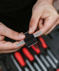 Four Piece Built For The Grind Anti Vibration Rubber Studs M10 Double Screw Mounts being applied on a threaded metal rod.
