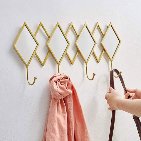 Dang Solid Wall Mount Coat Hook Featuring Heavy Duty Wrought Iron Craft With A Slick Rustic Copper And Gold Finish holding a pink scarf.