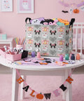 Dope Boo Halloween Basket For Kids With Pink Bow Glowing Ghost Canvas Trick Or Treat Tote Sweet Candy Storage Bin on table with crafts.
