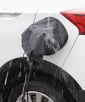 Magnetic EV Port Protector Hella Waterproof Plug Cover with Strong Grip Magnet blocking rain on electric vehicle charging port.