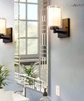 Pair Of Farmhouse Style Oil Rubbed Bronze Wall Sconces With Seeded Glass Shades in bathroom mirror reflection