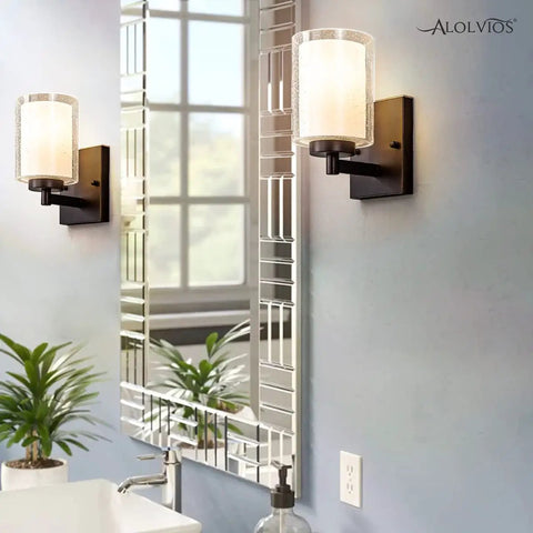 Pair Of Farmhouse Style Oil Rubbed Bronze Wall Sconces With Seeded Glass Shades in bathroom mirror reflection