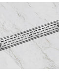 60 Cm Heavy Duty Square Invisible Floor Drain For Bathrooms And Showers Gravity Self Closing Stopper on marble tile with water droplets.