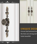 Close-up of green bronze vintage-style door knob back plates installed on white cabinet doors, illustrating design details. Product: Four Pack Vintage Style Door Knob Back Plates And Cabinet Drawer Pulls For Home Furniture Dressers Closets Wardrobes With Screws Green Bronze Finish Built For Long Lasting Use.