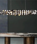 Slick Postmodern Led Pendant Lamp Bringing That Sick Dining Room Vibe With A Minimalist Modern Chandelier Design To Totally Elevate Your Home Cookout Setup Or Restaurant Space, hexagonal design, chrome finish, over a stylish table.