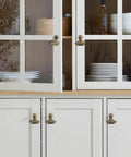 White cabinets with Ginkgo Leaf Knob Handles Six Pack Antique Brushed Bronze Pendant Pulls, 2.2 inch zinc alloy, installed in a kitchen.