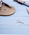 Built Like A Tank Stainless Steel Eye Bolts M10x60 Heavy Duty Hardware Kit With Locking Nuts And Washers on blue wood background.