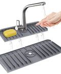 Silicone Sink Splash Guard Behind Faucet Drip Catcher Mat Keeps Counters Dry Countertop Saver 14.5x5.4 Inch Grey in use with faucet