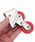 Heavy Duty Double Wheel Door And Window Rollers Super Smooth Stainless Steel Track Pulleys held in hand with red wheels.