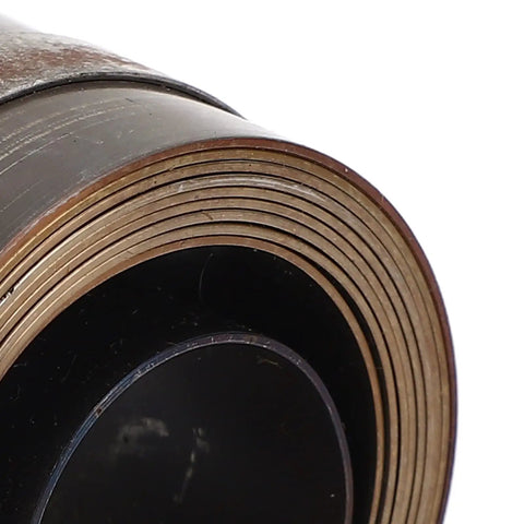 Close-up of a rolled Chrome Plated Drill Press Return Spring Set For Bench, Horizontal, And Vertical Drills, robust spring steel.