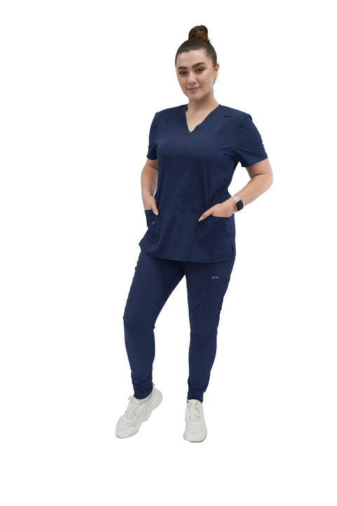 Womens Five Pocket V Neck Scrub Top For Medical Bosses Straight Fire Navy Nursing Uniform Featuring Relaxed Stretch Fabric For All Day Clinic Comfort And Fresh Style, model wearing navy scrub top and pants.