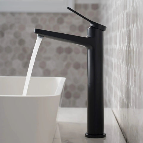 Indy Single Handle Vessel Bathroom Faucet In Matte Black With Solid Brass Construction in action beside a white vessel sink