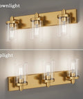 Slick Gold Vanity Light With 3 Lights For Bathroom Over Mirror Modern Wall Sconce With Clear Glass Shades Durable Aluminum Construction 24.5 Inch Long Vanity Lighting Fixture No Bulbs Included shown in downlight and uplight installations.