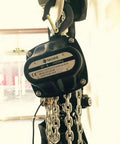 Built Tough Manual Chain Block Hoist 2 Pack Featuring Hella Strong Galvanized Steel Chain And 2200 Lb Capacity With 30 Ft Length For No Sweat Industrial Rigging close-up of a 1000 kg manual chain hoist with metal hook and chain.