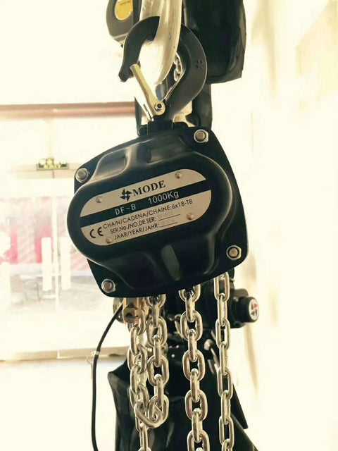 Built Tough Manual Chain Block Hoist 2 Pack Featuring Hella Strong Galvanized Steel Chain And 2200 Lb Capacity With 30 Ft Length For No Sweat Industrial Rigging close-up of a 1000 kg manual chain hoist with metal hook and chain.