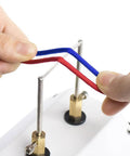 Hands holding red and blue cords in an electric hot seam smoother for crafting, showing cord positioning.