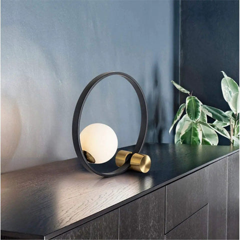 Mid Century Modern Nightstand Lamp In Black Matte Metal With Frosted Glass Globe Round Desk Table Light On Dark Wood Surface