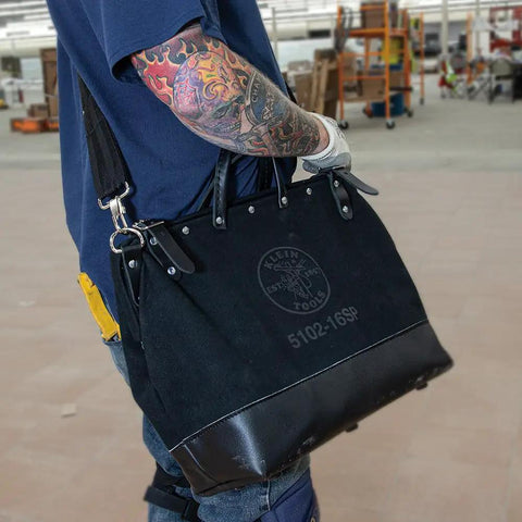 Person carrying Deluxe 16 Inch Canvas Tool Bag With 13 Pockets And Detachable Shoulder Strap Large Heavy Duty Organizer For Tools