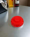 Two Pack Red Abs Ibc Container Lid Covers With Vent Holes And Valve Caps For Secure Sealing Quick Liquid Access Smooth Flow Protection On 550 Gallon Water Barrels on a silver table.