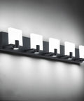 Slick Black LED Vanity Light 4 Light Modern Bath Fixtures Above Mirror Dimmable Wall Mount Matte Black Back Plate With White Acrylic Shade 34.7 Inch Length Energy Saving 40W LED Lighting displayed horizontally with lit acrylic shades