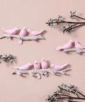 Chic Five Hook Wall Mounted Coat Rack With A Cool Blue Bird Vibe features pink bird designs on branches for decorative storage.