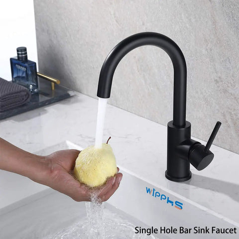 Person rinsing a pear under Matte Black Bar Sink Faucet With Single Hole Design in a kitchen setting