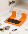 90 Degree Cabinet Hinge Installation Tool With Magnetic Mounting for Woodworking on display with hinges and screws