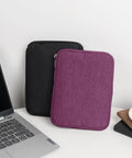 Travel Ready Watch Band Organizer Case With Waterproof Nylon Zipper Closure Ample Pocket Space, purple and black cases on desk.