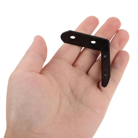 Person holding Heavy Duty L Shaped Corner Brace from 20 Pack Two Sizes 90 Degree Shelf Supports with black finish
