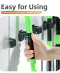 Hand holding tool in 5 Pack Heavy Duty Wall Mount Broom Holder Rack For Mop Broom Rake And Garden Tools Stainless Steel Hanger