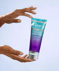 Hands holding Tropical Moringa Sweet Oil And Honey Endless Moisture Hair Cream For Curly Hair Defining Curls Frizz Control Deep Hydration Elasticity Boost Shine Lock In Lightweight Yet Rich Moisturizer 8 Ounce tube