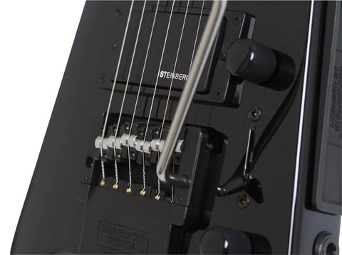 Spirit GT Pro Deluxe Black Electric Guitar With Gig Bag Maple Body Locking Tremolo R Trem System Humbucker Neck Pickup And Single Coil Middle Pickup Lightweight Built For Stage Ready Studio And Street Jams close-up of black R-Trem bridge and Steinberger neck pickup