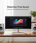 Next Level Desk Speakers With Bluetooth 5.0 And 62W RMS Power, white, on a desk beside a computer monitor.