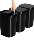 3 Pack Slim Trash Can With Pop Up Lid 2.6 Gallon 10 Liter Black Waste Bins For Bathroom Kitchen Office Bedroom Under Sink Compact Design Great For Small Spaces Under Sinks Desks Cabinets And In Bathrooms Or Kitchens, with one lid being opened by hand.