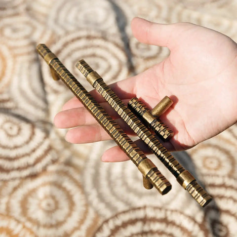 Hand holding Antique Brass T Bar Cabinet Pulls 7.56 Inch Center Knurled Zinc Alloy Handles 6 Pack Affordable Luxury Dope Hardware